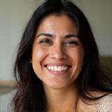 Headshot of satisfied client Fatima Khan, smiling happily.