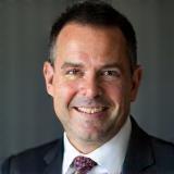 Headshot of satisfied client James Williams, with a confident expression.