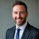 Headshot of satisfied client Thomas Anderson, smiling professionally.